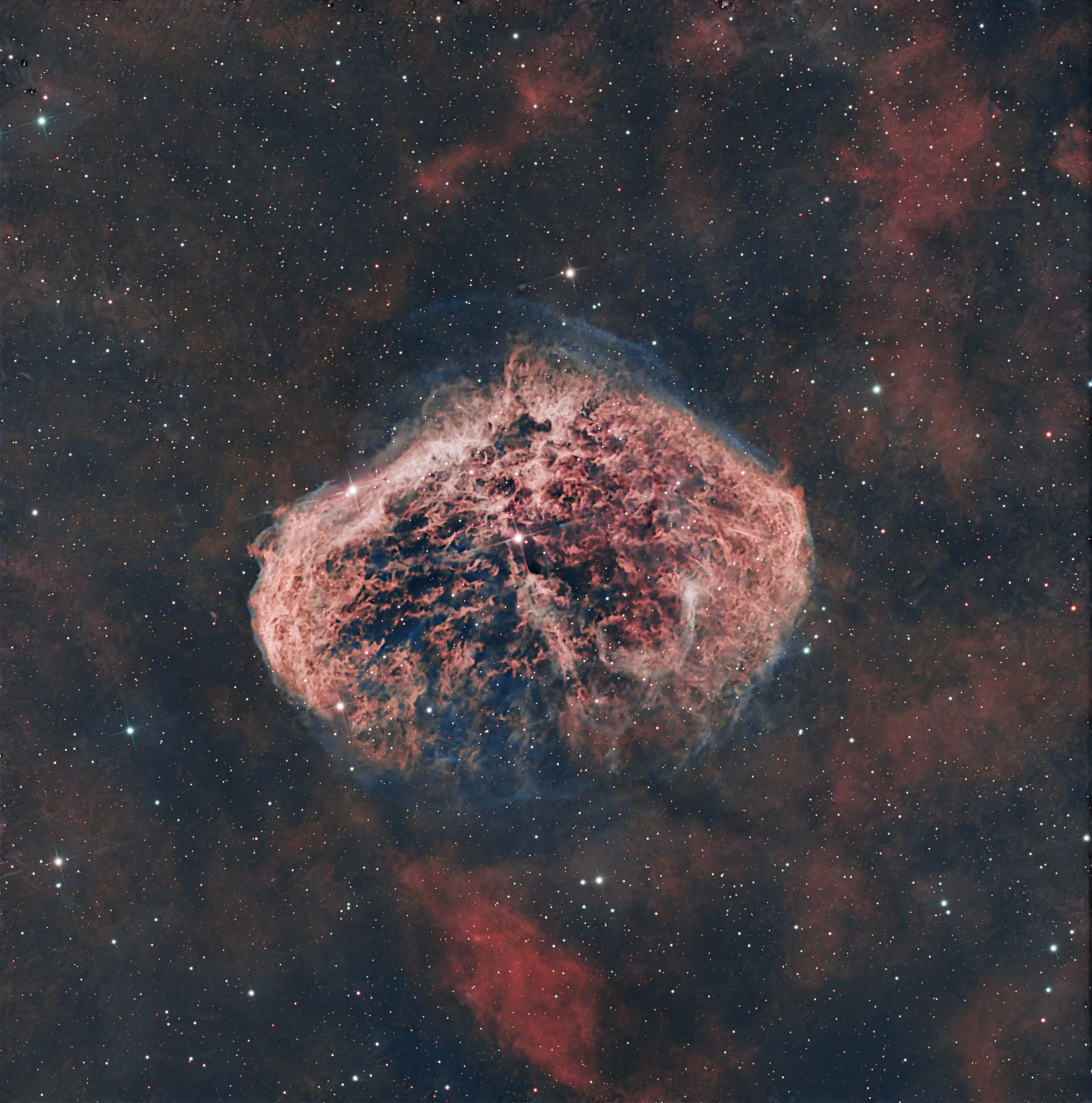 The Crescent Moon Nebula NGC 6888 is a peculiar emission nebula in the constellation Cygnus, excited to glow by the Wolf-Rayet star at the nebula's center.
